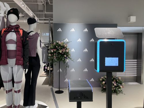 Branded photobooth with custom Adidas step and repeat backdrop at a retail brand activation in Amsterdam - Smilen.nl
