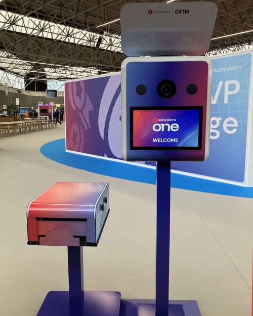 Branded photo booth and matching printer stand at OutSystems ONE 2026 in Amsterdam